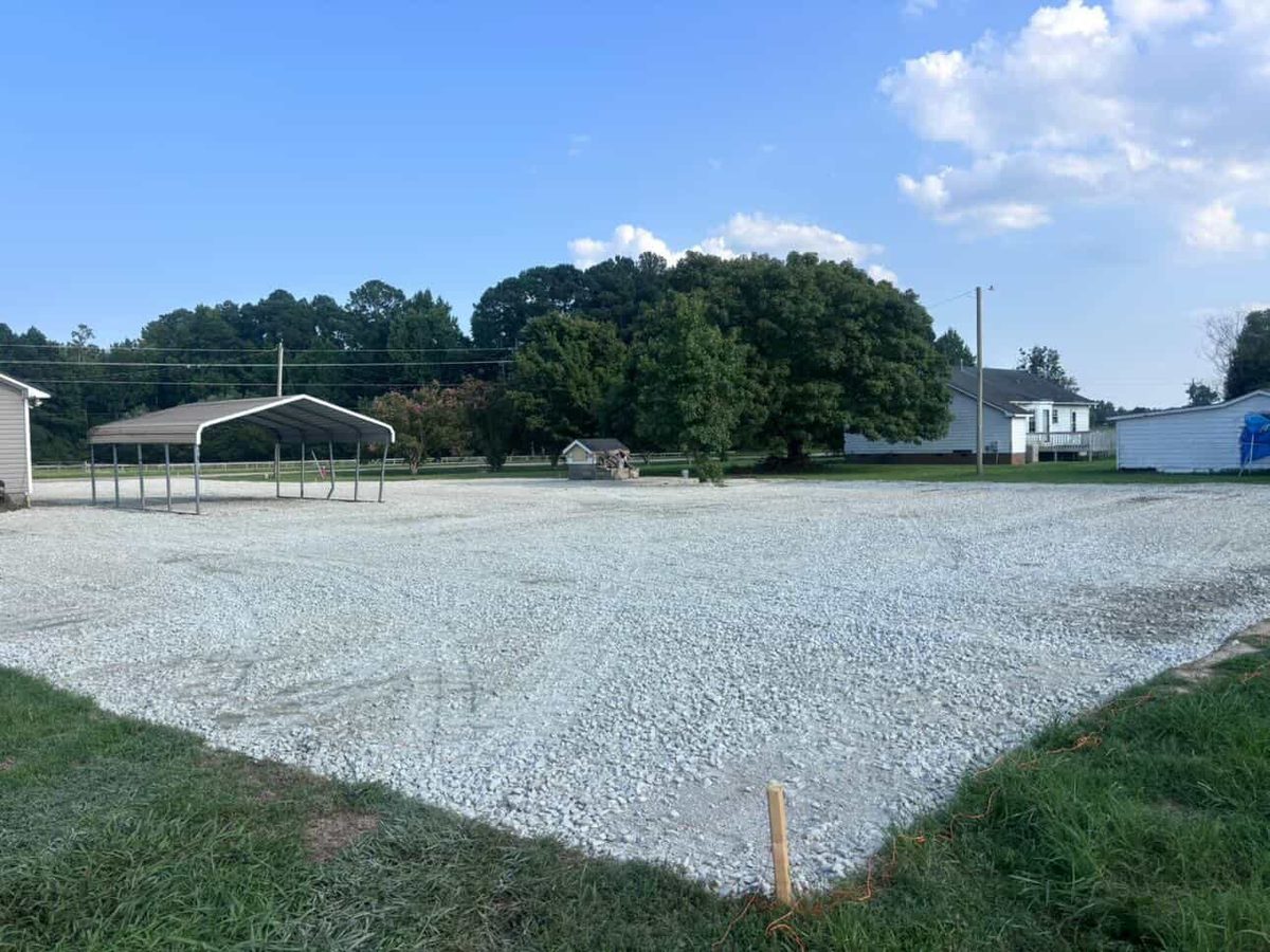 The same lot finished with a fresh, level layer of white gravel.